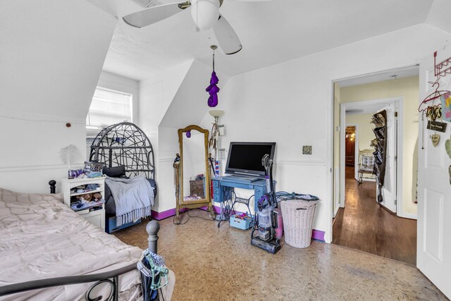 bedroom with ceiling fan, lofted ceiling, and hardwood / wood-style floors