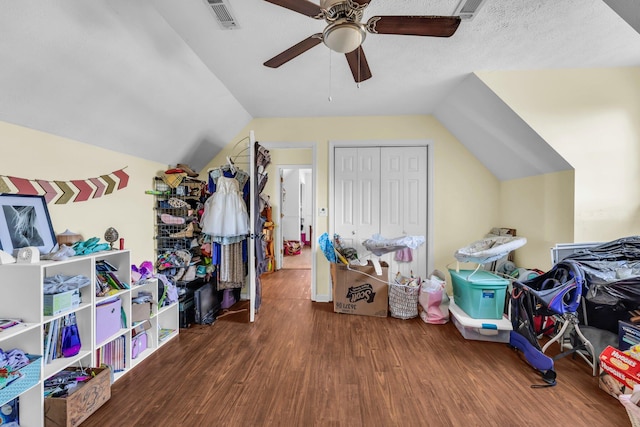 interior space with lofted ceiling, hardwood / wood-style floors, a textured ceiling, and ceiling fan