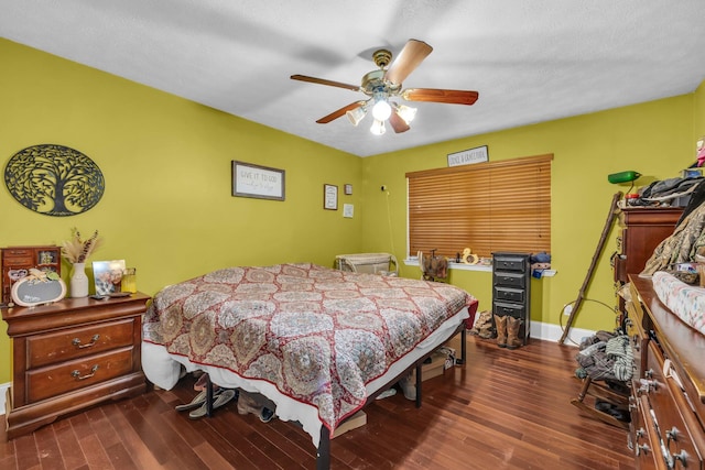 bedroom featuring dark hardwood / wood-style floors, a textured ceiling, and ceiling fan