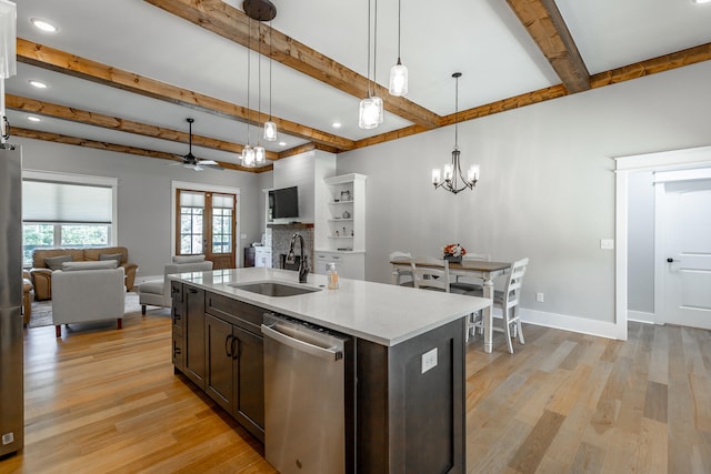 kitchen featuring light hardwood / wood-style flooring, stainless steel appliances, a center island with sink, sink, and decorative light fixtures