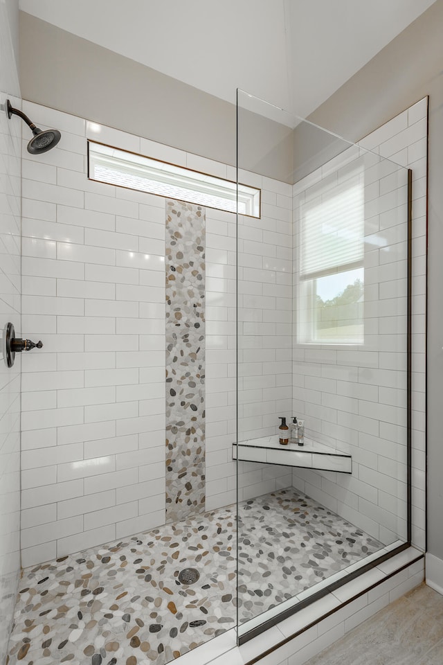 bathroom with tile patterned floors and walk in shower