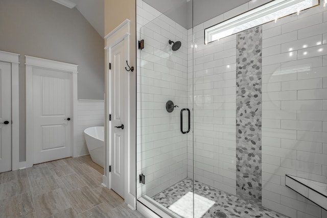 bathroom featuring lofted ceiling and separate shower and tub