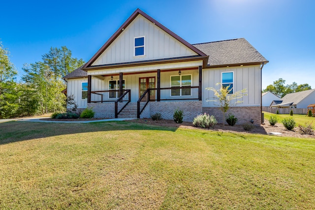 view of front of home featuring covered porch and a front yard