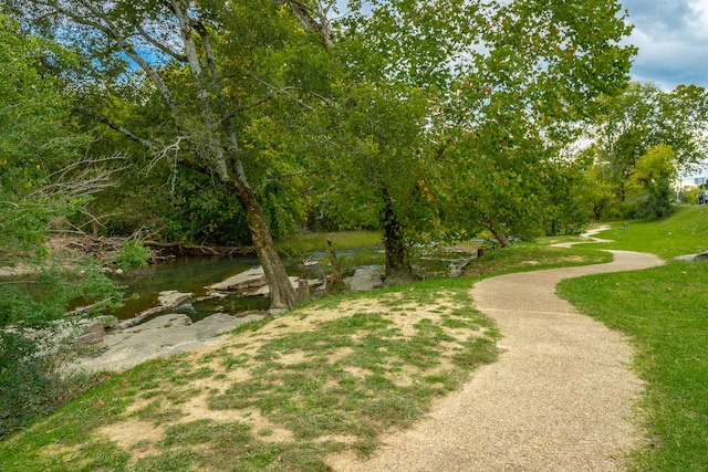 view of community featuring a lawn and a water view