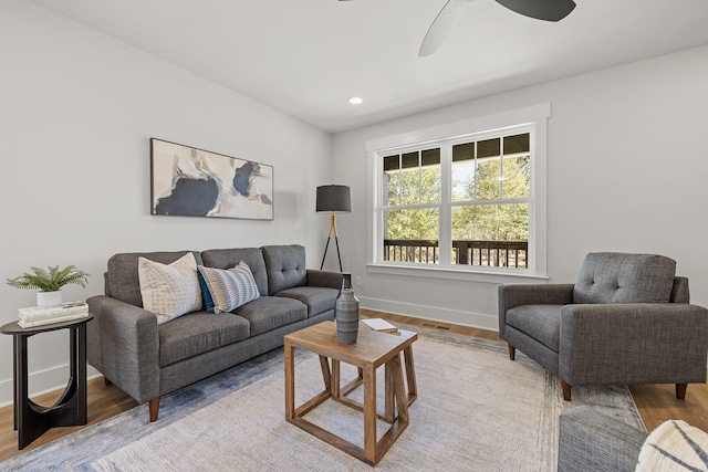 living room featuring light hardwood / wood-style floors and ceiling fan