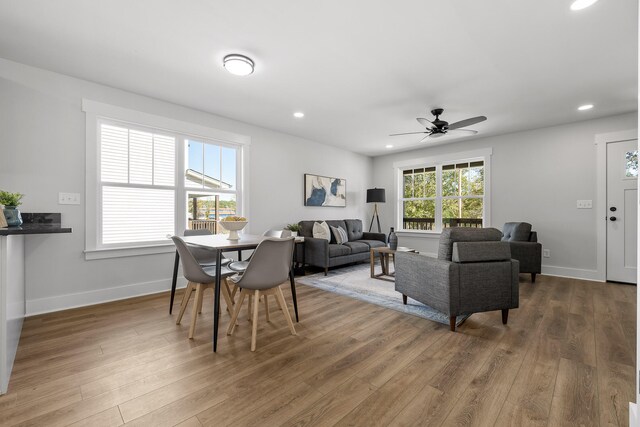 living room featuring hardwood / wood-style flooring, ceiling fan, and a wealth of natural light