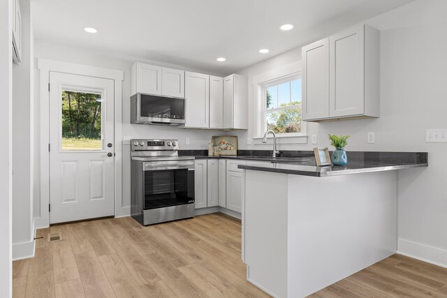 kitchen featuring white cabinetry, a healthy amount of sunlight, and appliances with stainless steel finishes