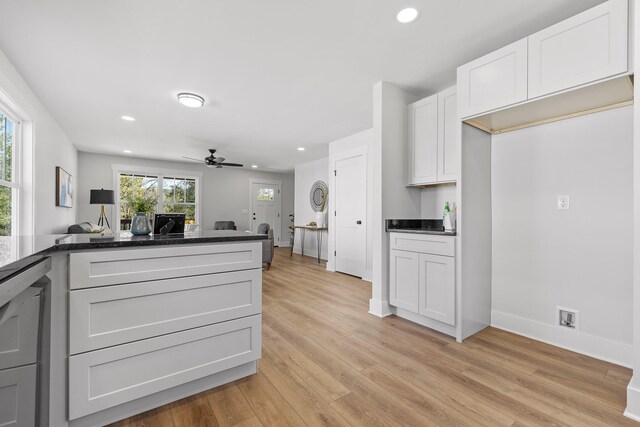 kitchen with light hardwood / wood-style floors, kitchen peninsula, white cabinetry, and ceiling fan