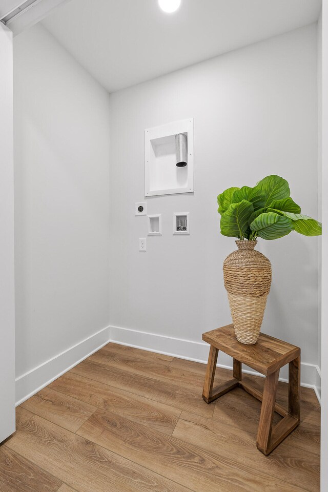 washroom featuring hookup for an electric dryer, hardwood / wood-style floors, and washer hookup