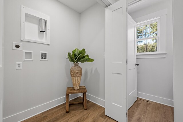 interior space featuring light hardwood / wood-style flooring and hookup for an electric dryer