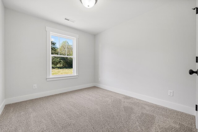 unfurnished room featuring carpet