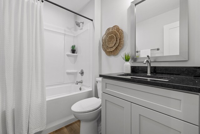 full bathroom with vanity, toilet, hardwood / wood-style flooring, and shower / bathtub combination with curtain