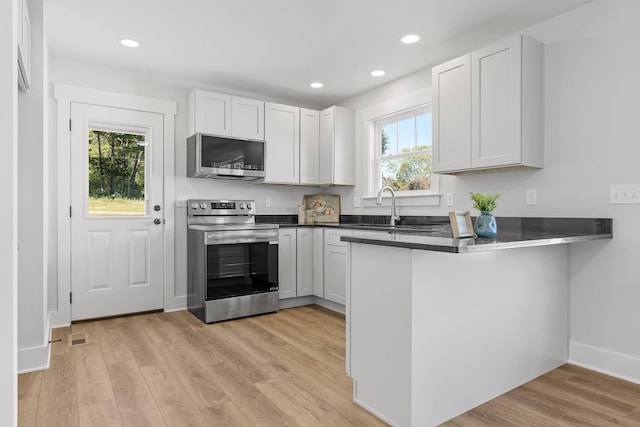 kitchen with white cabinetry, appliances with stainless steel finishes, and plenty of natural light