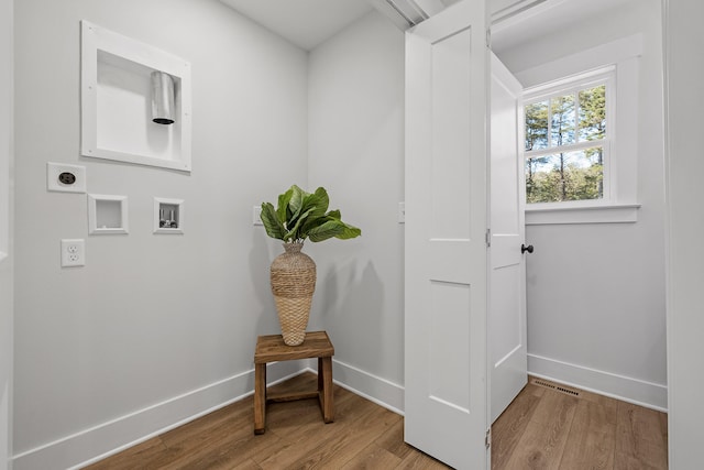 interior space featuring light wood-type flooring and electric dryer hookup