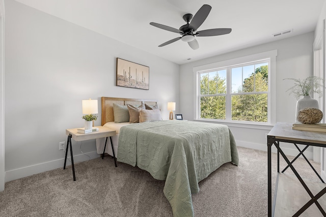 bedroom with light colored carpet and ceiling fan