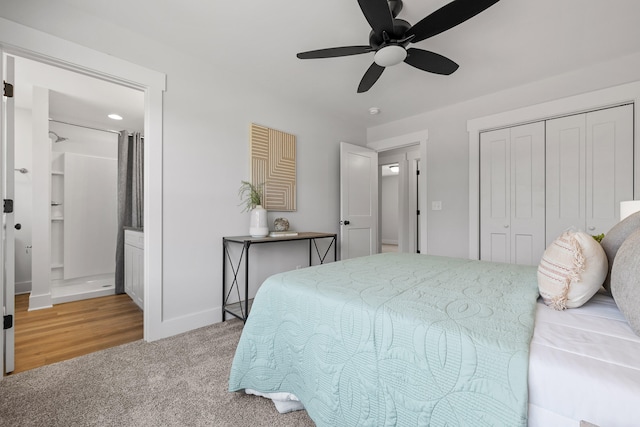 carpeted bedroom with a closet, connected bathroom, and ceiling fan