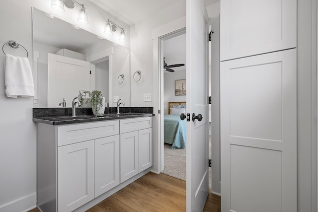 bathroom featuring vanity, wood-type flooring, and ceiling fan