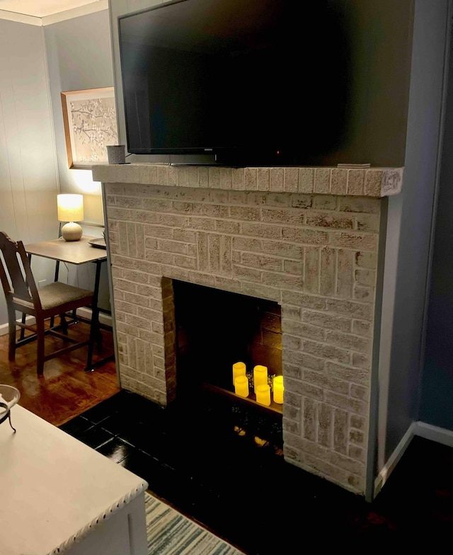 interior details with hardwood / wood-style flooring, a fireplace, and ornamental molding