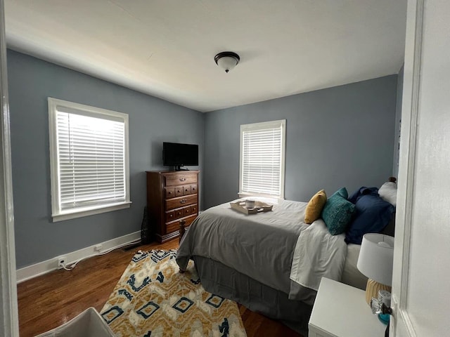 bedroom with dark hardwood / wood-style floors