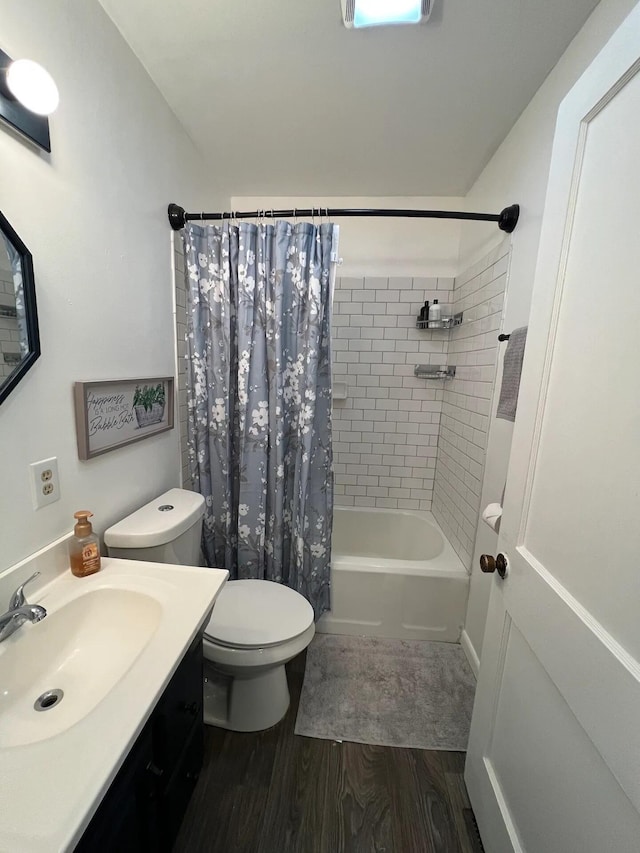 full bathroom featuring shower / bath combination with curtain, wood-type flooring, vanity, and toilet