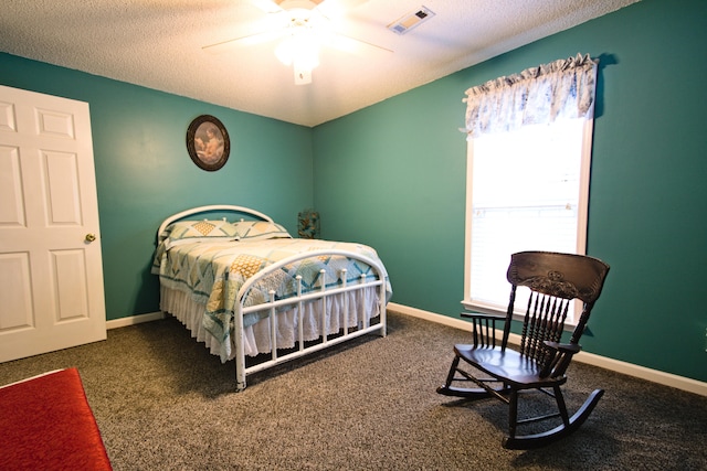 bedroom featuring carpet, ceiling fan, and a textured ceiling