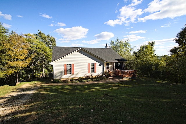 view of side of home with a lawn and a deck