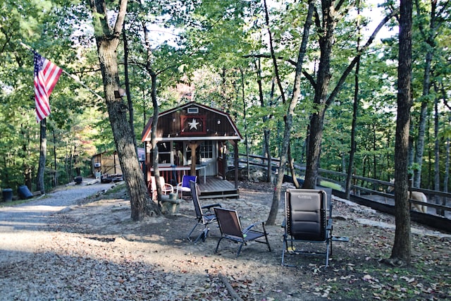 view of yard featuring a deck and an outdoor structure