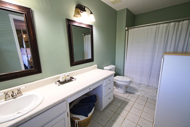 bathroom featuring vanity, tile patterned flooring, toilet, walk in shower, and a textured ceiling