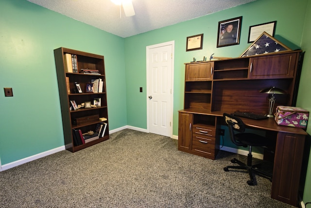 office area with ceiling fan, dark carpet, and a textured ceiling