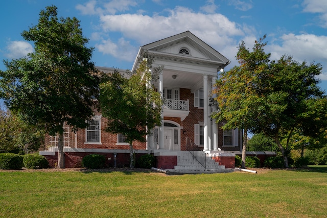 greek revival house with a front yard