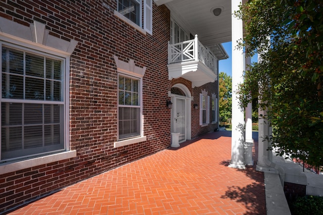 view of patio featuring a balcony