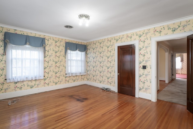 unfurnished bedroom featuring hardwood / wood-style flooring and ornamental molding