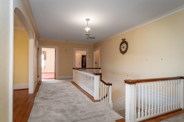 corridor featuring ornamental molding and light wood-type flooring