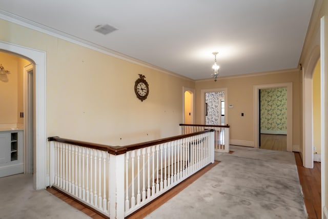 hall featuring light wood-type flooring and crown molding