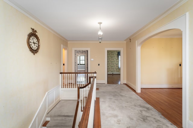 hallway with wood-type flooring and ornamental molding