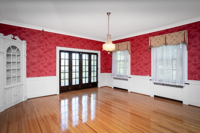 unfurnished dining area featuring wood-type flooring and plenty of natural light