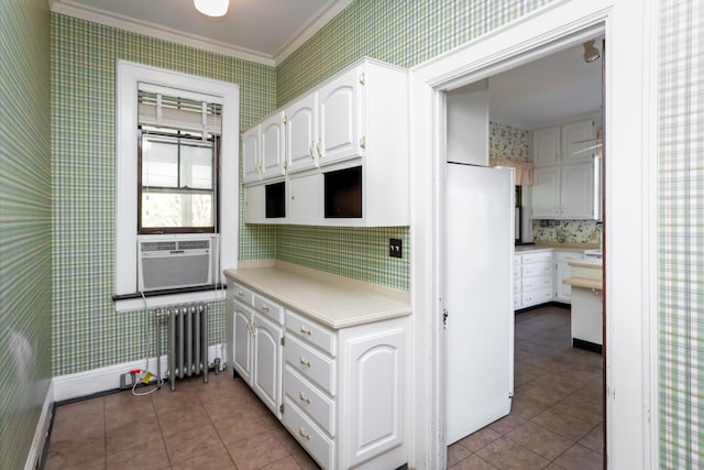 kitchen featuring white cabinets, radiator heating unit, tile patterned flooring, and crown molding