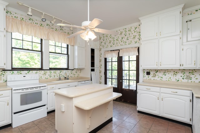 kitchen featuring white cabinetry, white electric range, and a wealth of natural light