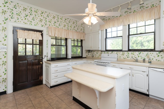 kitchen featuring a center island, white appliances, crown molding, sink, and white cabinetry