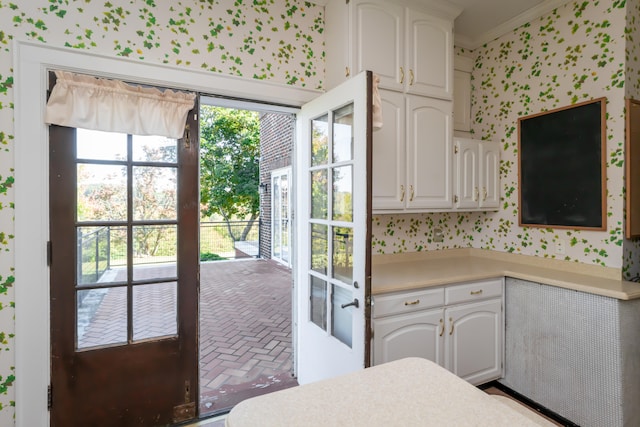 kitchen featuring french doors, white cabinets, and ornamental molding