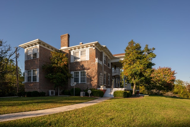 italianate home featuring a front yard and central air condition unit