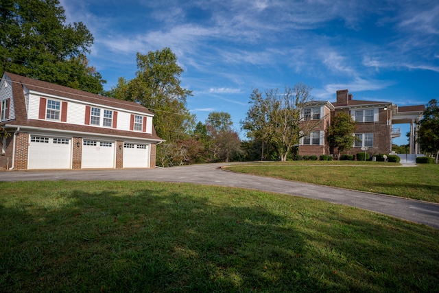 view of side of property featuring a lawn and a garage