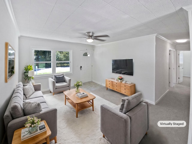 living room with baseboards, carpet floors, ceiling fan, and crown molding