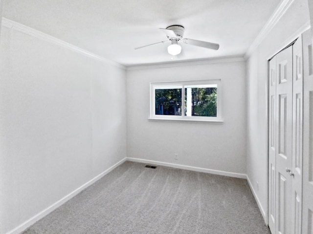 unfurnished bedroom with ceiling fan, carpet flooring, and ornamental molding