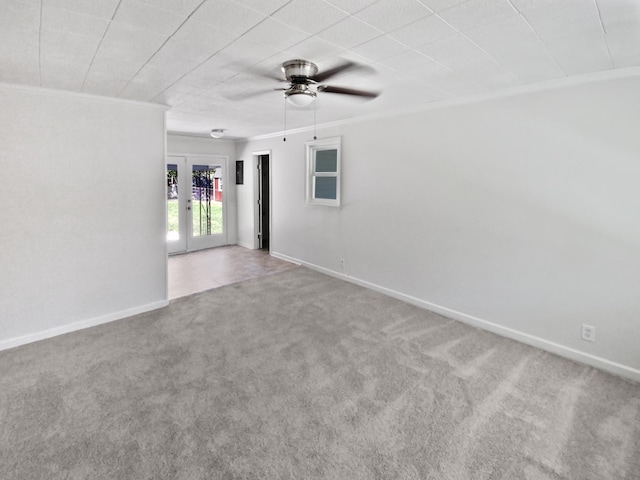 spare room featuring crown molding, carpet floors, french doors, and ceiling fan