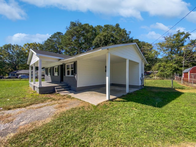 view of side of property featuring a patio area and a yard