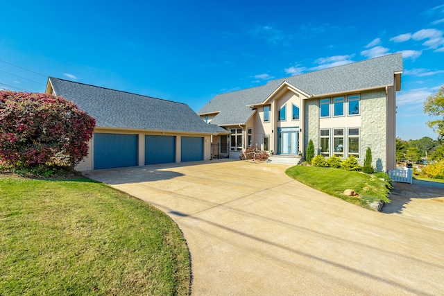 view of front of home featuring a garage and a front lawn