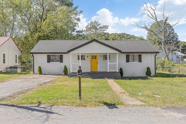 single story home with a front yard and a porch