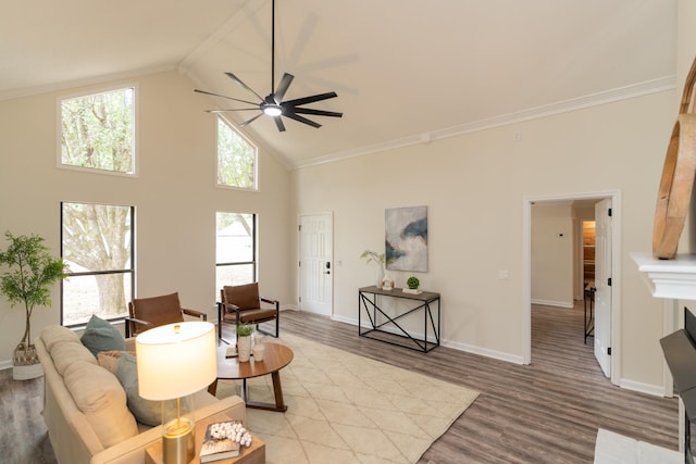 living room featuring a wealth of natural light, light hardwood / wood-style flooring, high vaulted ceiling, and ceiling fan