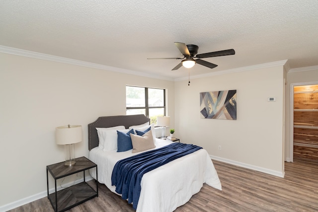 bedroom with dark wood-type flooring, crown molding, a textured ceiling, and ceiling fan